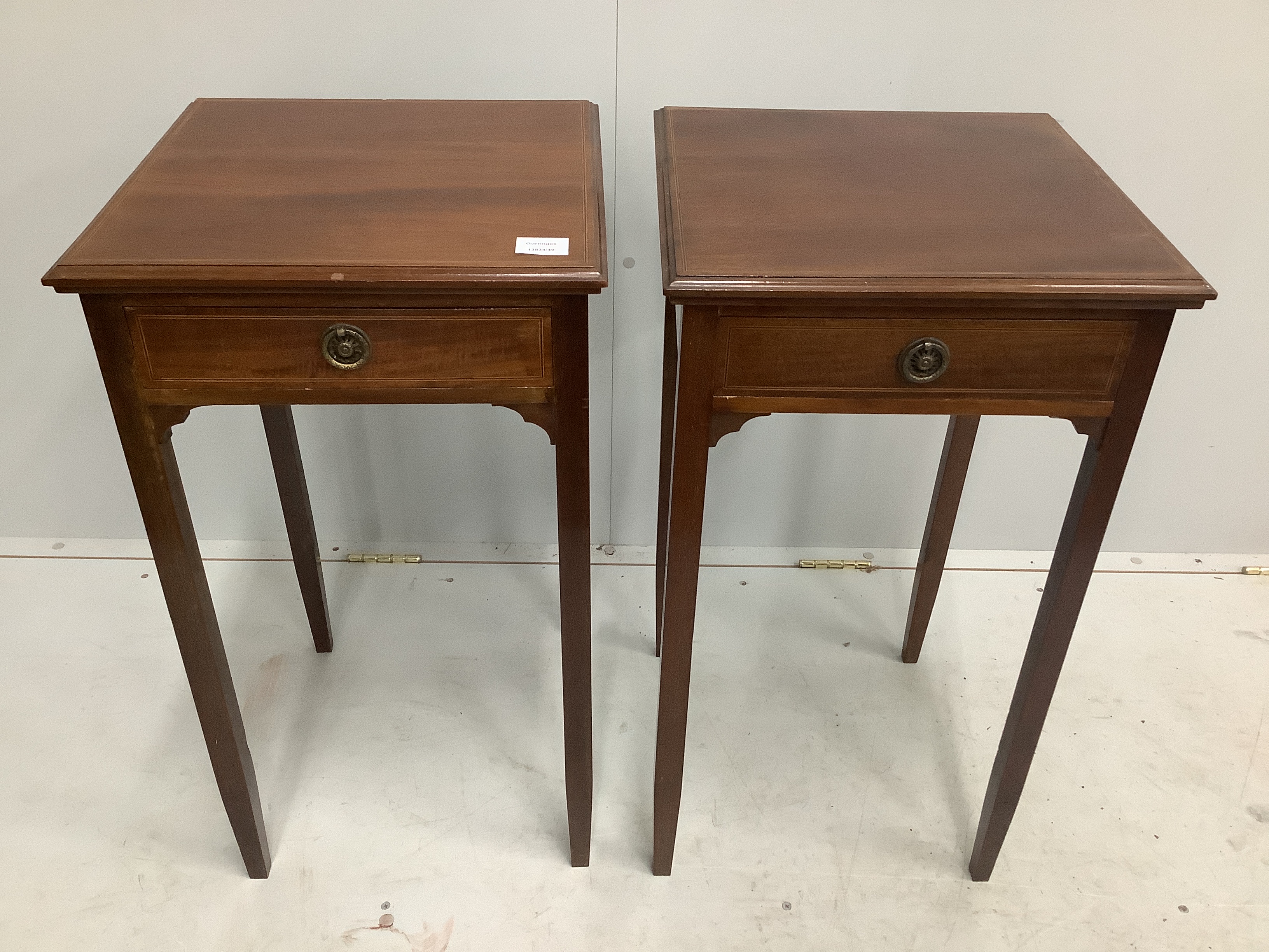 A pair of reproduction George III style mahogany bedside tables, with blind fret aprons, on square moulded legs, width 40cm, depth 40cm, height 73cm